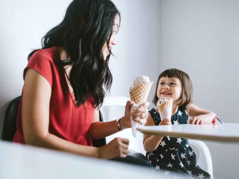 A woman and child are eating ice cream.