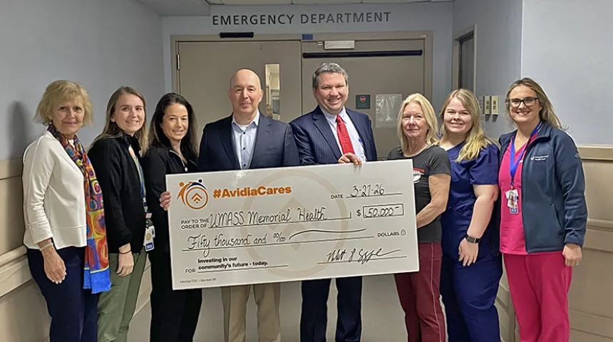 A group of caregivers and Rob Cozonne, President and CEO of Avidea Bank pose holding an extra large-size check representing the $50,000 donation to the expansion of the Marlborough Campus ED..