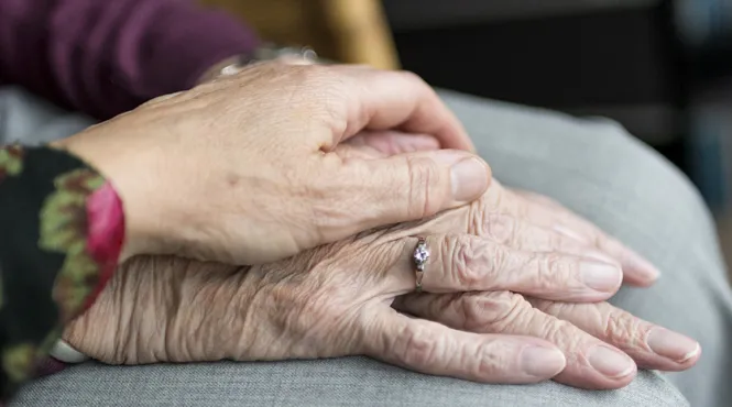 elderly hands on top of one another