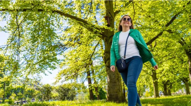 woman in jeans walking mindfully in a spring woods