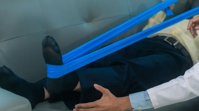 Man lying on couch doing physical therapy after same day joint replacement