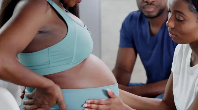 a doula helping a pregnant woman as part of the birth team