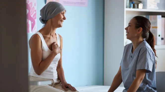 woman cancer patient talking to radiation therapy provider
