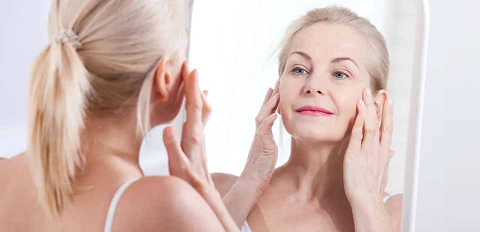 women looking at skin and wrinkles