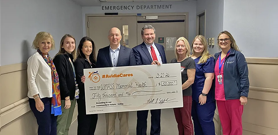 A group of caregivers and Rob Cozonne, President and CEO of Avidea Bank pose holding an extra large-size check representing the $50,000 donation to the expansion of the Marlborough Campus ED..