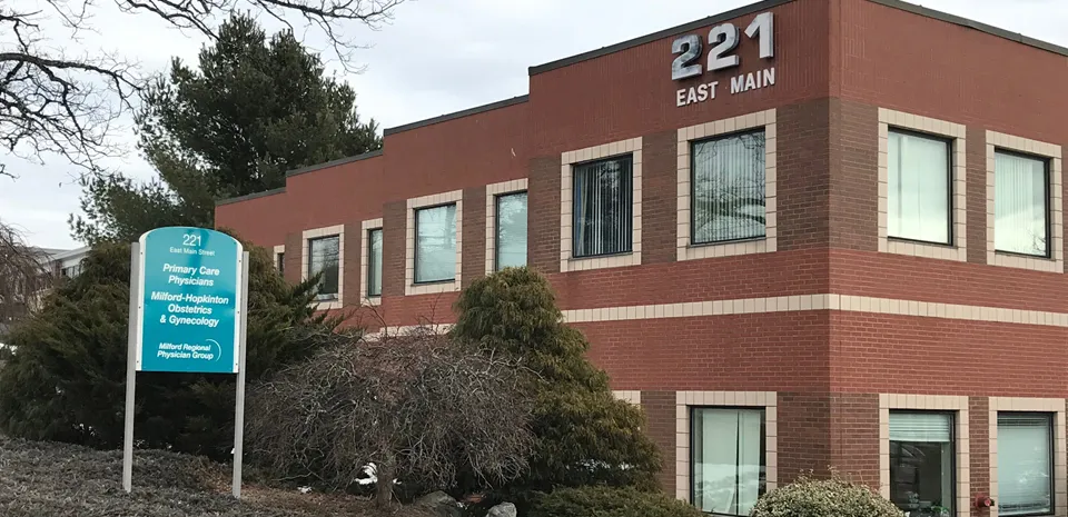 A brick building with a sign that reads "221 East Main."