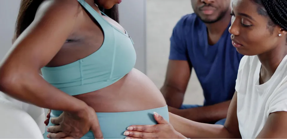 a doula helping a pregnant woman as part of the birth team