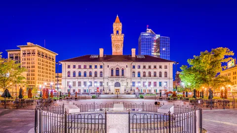 The Worcester City Hall is shown against a dark blue sky.