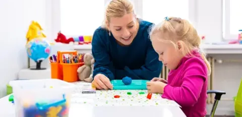 adult painting with child