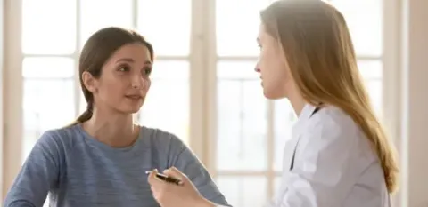 sick patient discussing treatment options with doctor