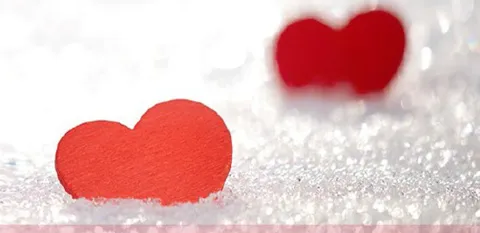 red paper hearts in snow