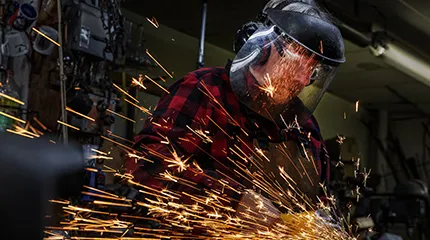 Blacksmith, John Hayden, John Hayden saws a shotgun barrel lengthwise during the process of turning it into a garden tool.