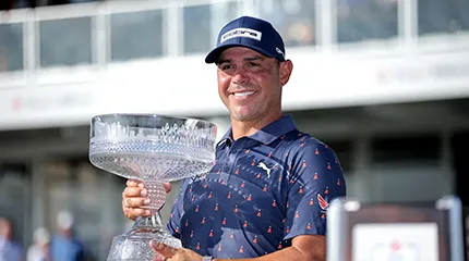 Gary Woodland holds up the championship trophy after winning the Texas Children's Houston Open golf tournament.