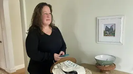 Colorectal cancer patient Tracy O'Rourke stands in her Worcester kitchen.