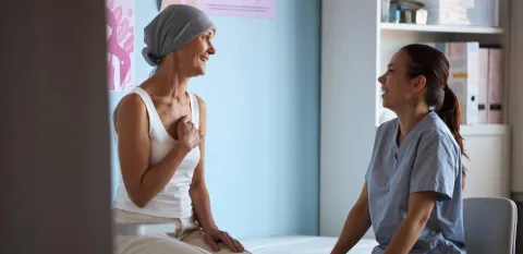 woman cancer patient talking to radiation therapy provider