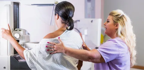 compassionate mammogram tech with a patient having a mammogram