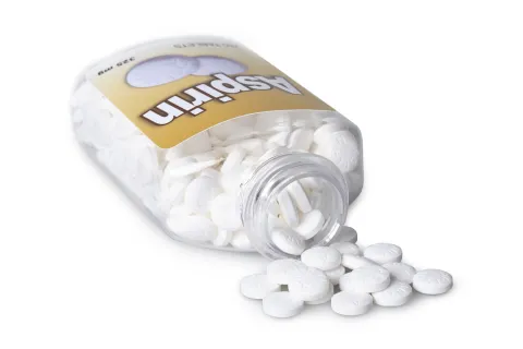 bottle of aspirin which could lower risk of colon cancer is tipped over