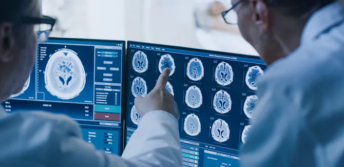 Two providers close together reviewing imaging