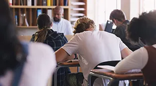 Teens are doing silent work in a school classroom.