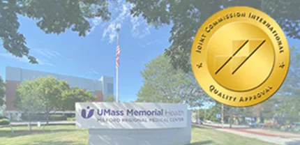 A gold logo for The Joint Comission is shown alongside an image of the front of Milford Regional Medical Center.