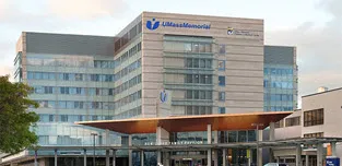 Exterior of a medical center with UMass Memorial Children's Medical Center logo visible above the main entrance on University Campus.