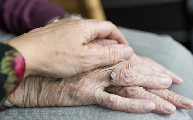 elderly hands on top of one another