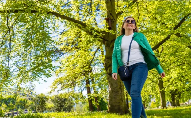 woman in jeans walking mindfully in a spring woods