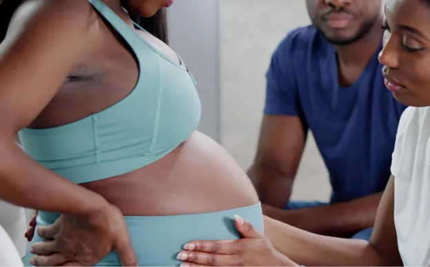 a doula helping a pregnant woman as part of the birth team