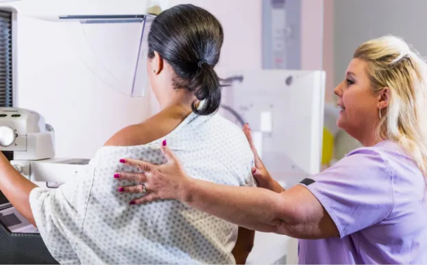 compassionate mammogram tech with a patient having a mammogram