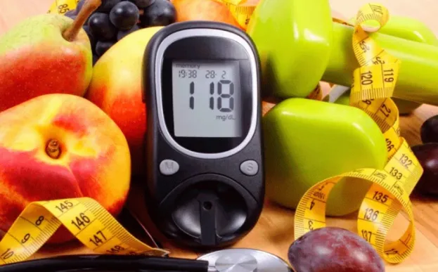 colorful fruits and veggies with a blood glucose monitor used to help achieve well controlled diabetes.