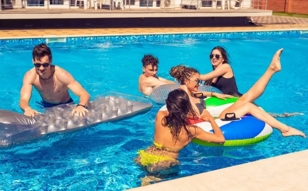 group of teens swimming in a pool