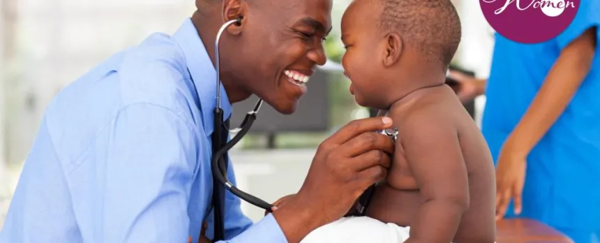 A doctor smiles to elicit a smile from the crying baby he is examining while holding a stethoscope to the baby's chest.