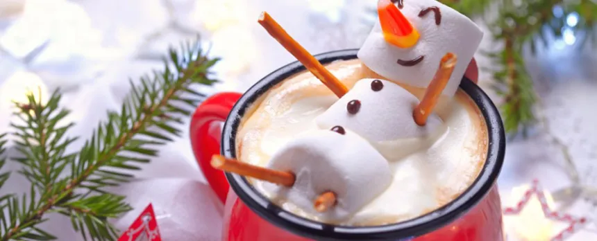 Red mug with hot chocolate and a melted marshmallow snowman