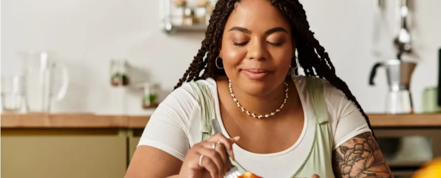 Women at a table eating mindfully enjoying each bite of food