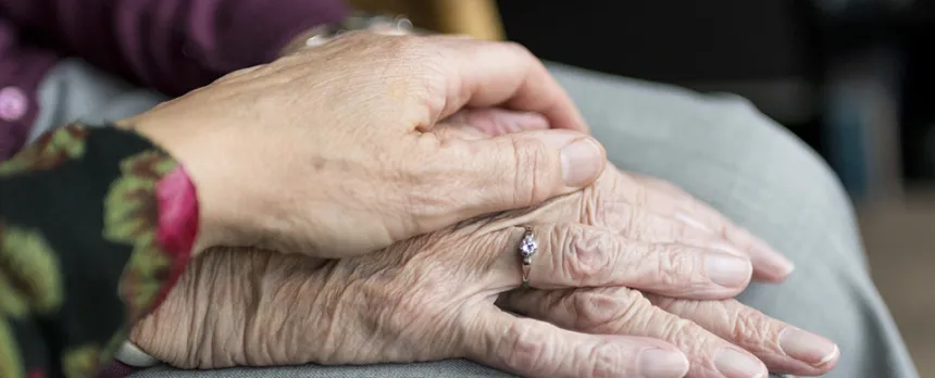 elderly hands on top of one another
