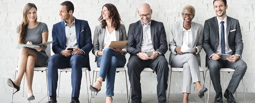 diverse group sitting in chairs and laughing