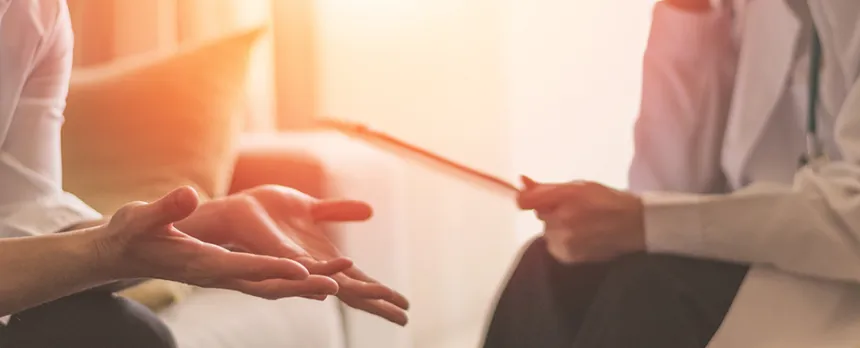 doctor and patient during a therapy session discussing treatment plan