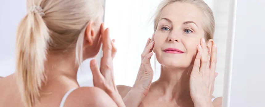 women looking at skin and wrinkles