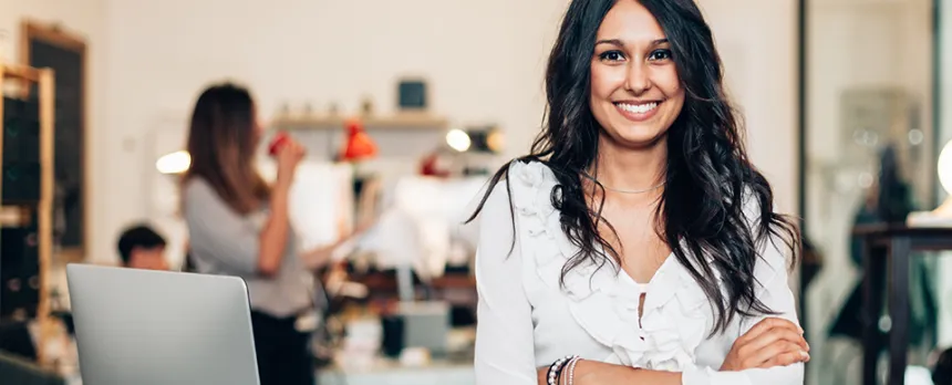diverse woman standing smiling for the camera in office space