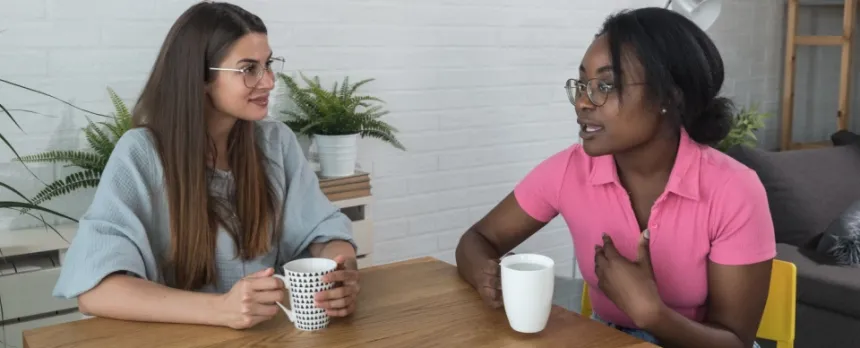 two women talking about advanced care planning over coffee