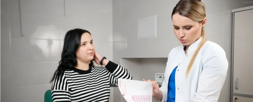 Woman in 20s at her first GYN appointment talking with the doctor