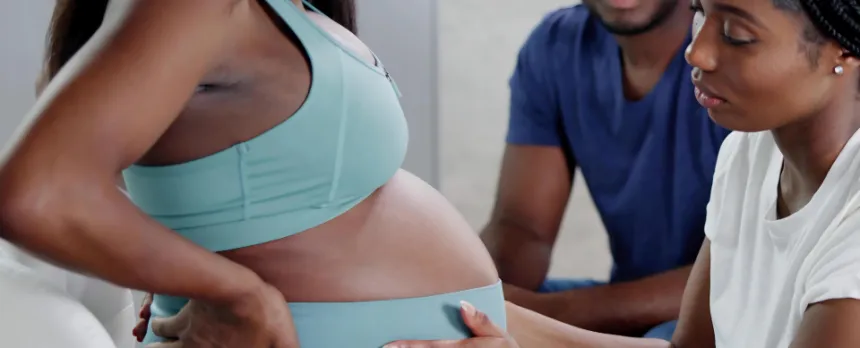 a doula helping a pregnant woman as part of the birth team