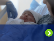 A mother holds her newborn after giving birth