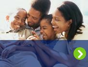 A smiling family is shown after an organ transplant.