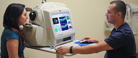 An eye specialist is taking images of a patient's eye.