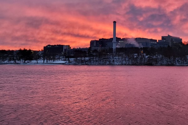 The view from across the lake in Shrewsbury. The sun sets and the sky reveals dramatic colors behind University Campus.