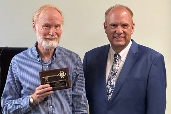 Mayor Joe Petty presents Dr. Hummel with a key to the city.