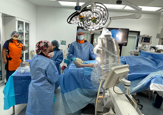 Doctors perform a procedure in the Operating Room