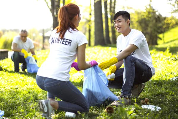 Photo of volunteers picking up trash in a park