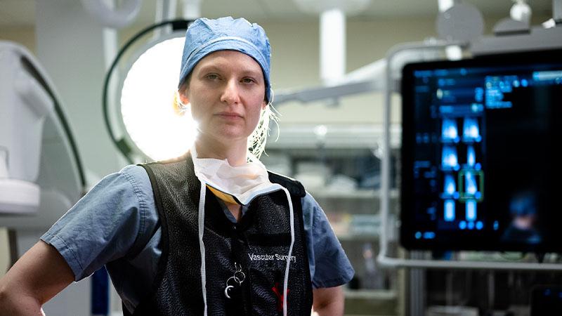 A surgeon stands in the operating room